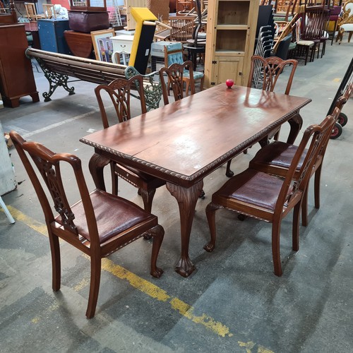 660 - A fabulous mahogany dining table and six Chippendale style chairs with red leather seats. Table and ... 