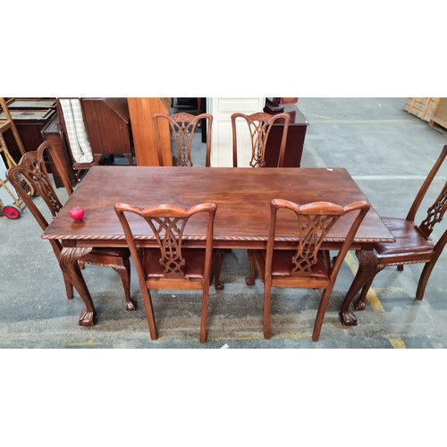 660 - A fabulous mahogany dining table and six Chippendale style chairs with red leather seats. Table and ... 