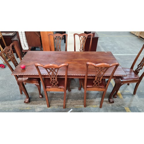 660 - A fabulous mahogany dining table and six Chippendale style chairs with red leather seats. Table and ... 