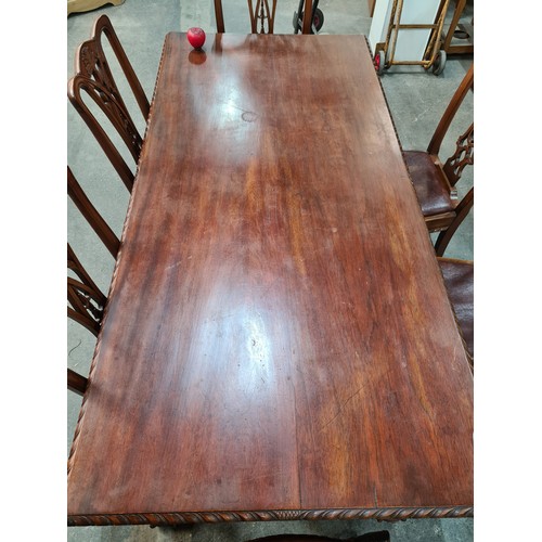 660 - A fabulous mahogany dining table and six Chippendale style chairs with red leather seats. Table and ... 