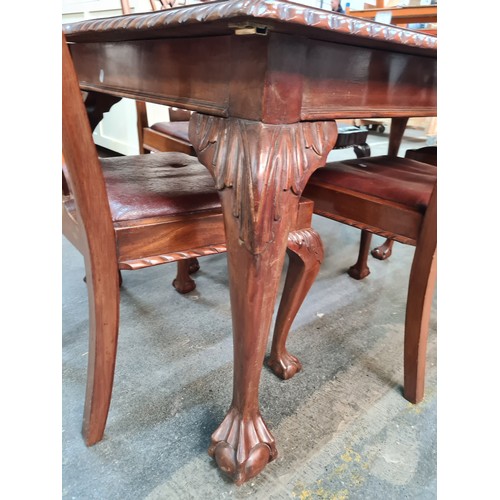 660 - A fabulous mahogany dining table and six Chippendale style chairs with red leather seats. Table and ... 