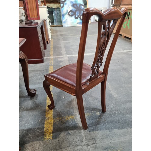 660 - A fabulous mahogany dining table and six Chippendale style chairs with red leather seats. Table and ... 