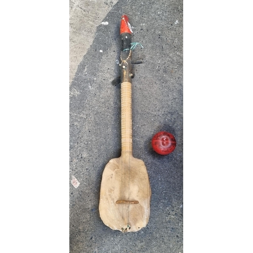 866 - A rare vintage long neck stringed instrument with a genuine turtle drum to base. Featuring three tun... 