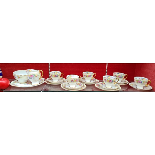 318 - A 20 piece Attractive tea set, with a lovely floral design, Thick gold band and gold handles.