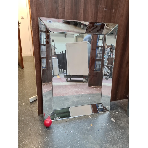 356 - A large Reflective and sleek, this contemporary-style mirror adds a polished touch to any space, wit... 