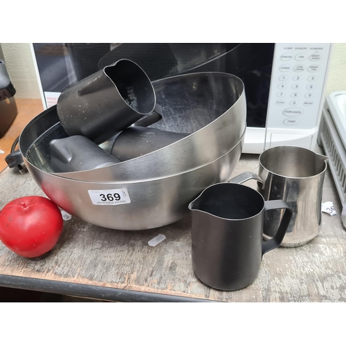 369 - A stainless-steel kitchen lot, including two large mixing bowl and 5 Milk steaming measuring pitcher... 