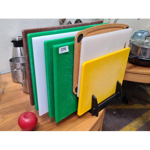 376 - Robust selection of professional-grade cutting boards in various colors, ideal for commercial use .