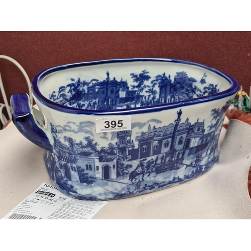 395 - A very large blue and white porcelain foot bath, featuring pastoral and architectural scenes, with a... 