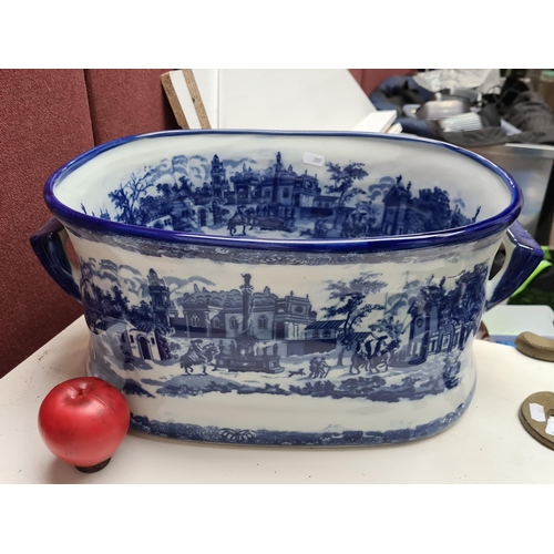 406 - A large Vintage style blue-and-white for bath, with pastoral scenes, rimmed in vibrant cobalt blue i... 