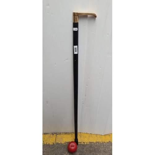 409 - Elegant vintage walking stick with brass handle and built in compass, featuring a distinctive red ru... 