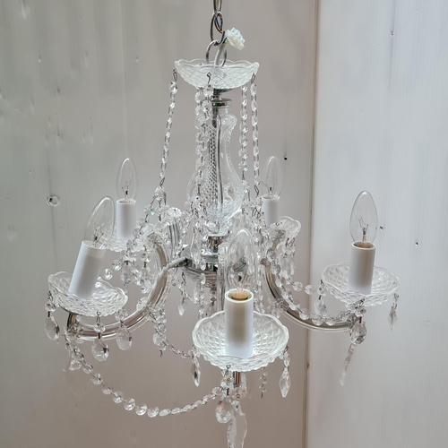 313 - Star Lot : Elegant crystal chandelier, sparkling with precision-cut glass droplets, poised to elevat... 