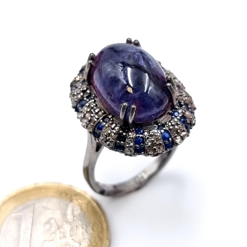 501 - Star Lot : A natural huge cabochon tazanite central stone 13.3 cts, weight of ring 8 grams, surround... 