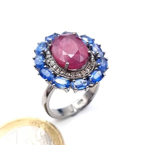 503 - Star Lot : A fabulous huge cabochon ruby  ring mounted  with 11 sapphires and diamond surround, rubi... 