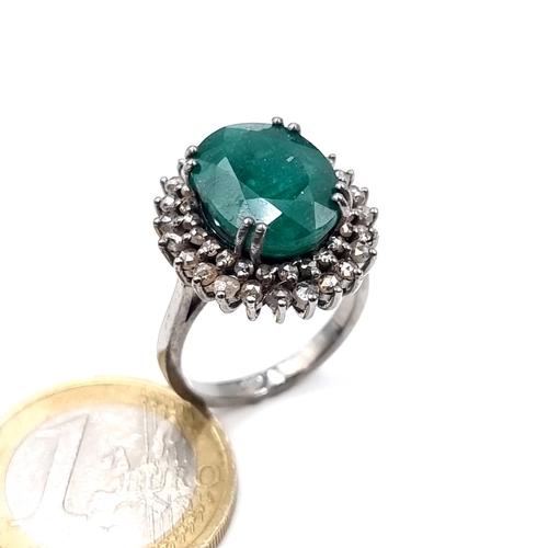 507 - Star Lot : A very fine emerald stone ring of 5.5 cts, with a diamond surround of 1 ct, ring mounted ... 