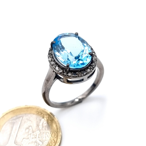 508 - Star Lot : A nice example of a blue topaz stone ring set with diamond surround mounted in a sterling... 