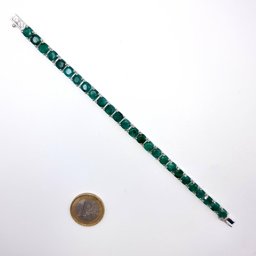 518 - Star lot : A very pretty beautifully matched natural Emerald mounted 26 stone line bracelet, weight ... 