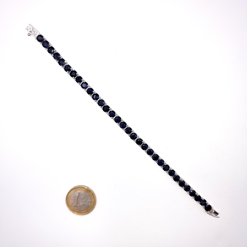 520 - Star lot : A fabulous 34 stone beautifully matched sapphire line bracelet, weight 17.52 grams. All s... 