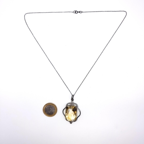 521 - A most attractive large citrine stone pendant set with diamond stone accents, length of chain 46cm, ... 