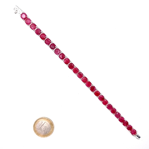 523 - A super example of a 26 gemstone natural ruby line bracelet set in sterling silver, weight 18.54 gra... 