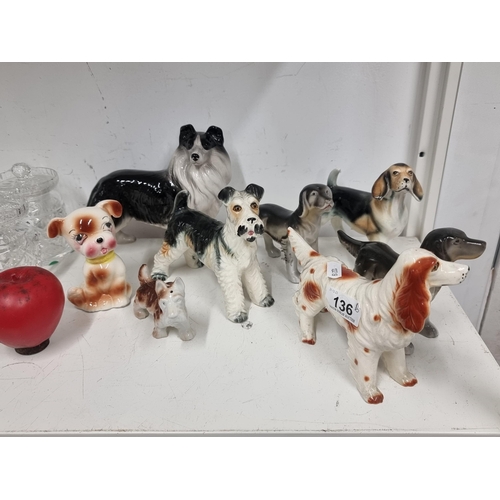 136 - A collection of eight charming ceramic dog figures.