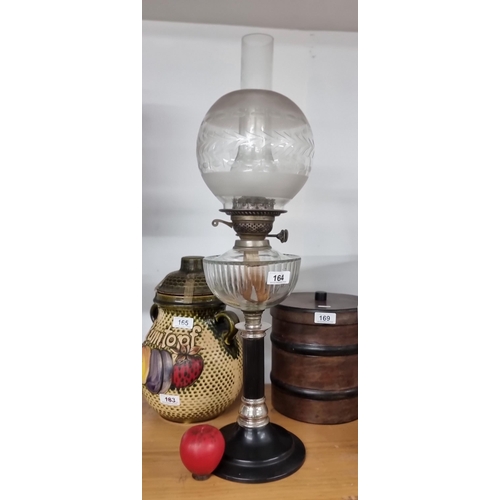 164 - A handsome vintage oil lamp featuring a lovely etched globe shade, chimney and clear reservoir. All ... 