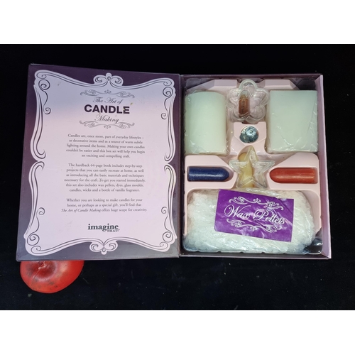 176 - An Imagine That! candle making kit containing wax pellets, candle holders, wicks, pigment sticks and... 