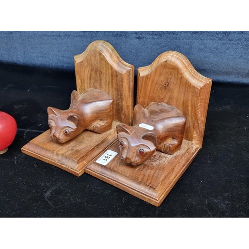 181 - A charming pair of solid wood bookends in the form of prowling cats.