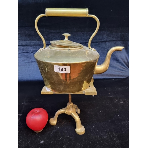 190 - A charming antique brass kettle accompanied by a tripod trivot stand.