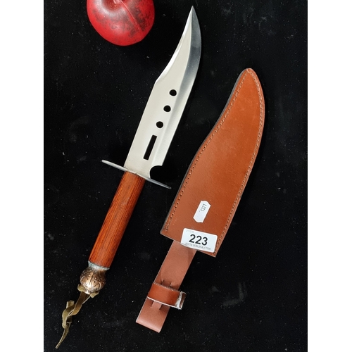 223 - A superb long blade bowie hand forged knife with original brown leather sheath.