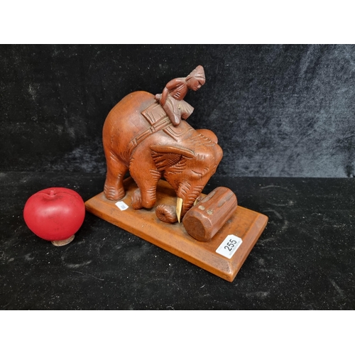 255 - An excellent large hand carved wooden sculpture of a working Indian elephant.