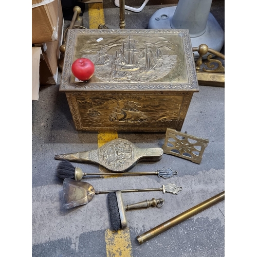 456 - A vintage brass plated wooden coal box featuring maritime scenes in repousse to sides and front. Fil... 