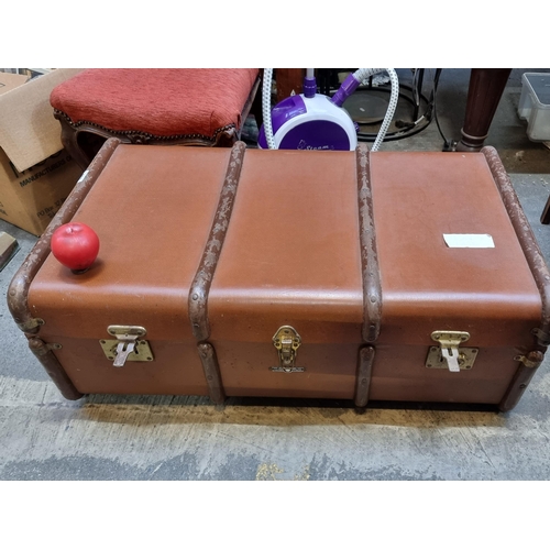 463 - A large vintage steamer trunk with brass reinforcements and studs to sides. Fabulous houndstooth pat... 