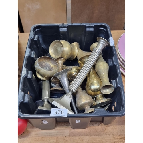 470 - A box of vintage brassware including vases and two silver toned candlesticks.