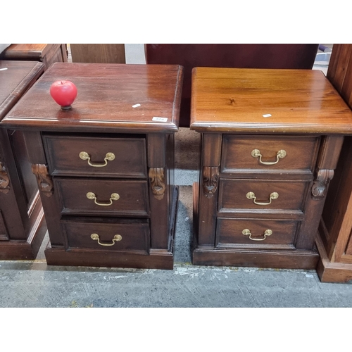 574 - Star Lot : Two beautiful well made hardwood bed side lockers. Featuring three drawers and brass drop... 