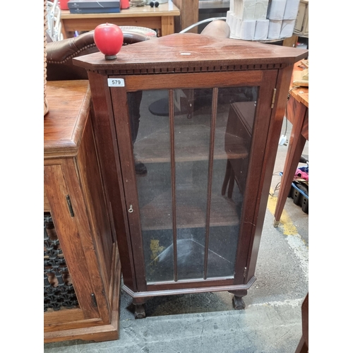 579 - A wonderful vintage mahogany corner unit boasting ball and claw feet and three internal shelves.