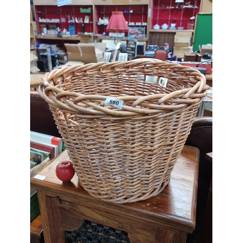 580 - A large wicker log basket.