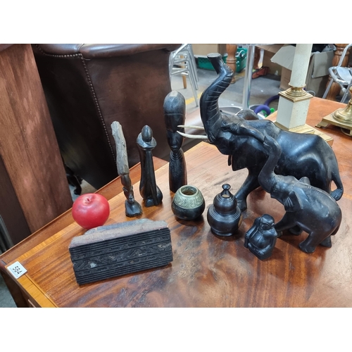 583 - A collection of vintage ebony items including two craved elephants, African carvings and an antique ... 