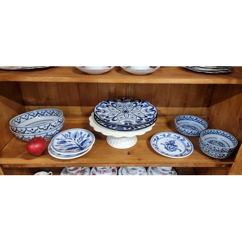 589 - A collection of eleven pieces of ceramics including fish bowls, two blue and white chargers and a ca... 