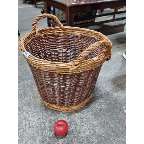 622 - A large double handled wicker log basket.