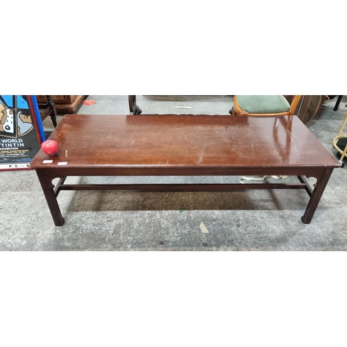 623 - A large vintage mahogany coffee table with stretcher.