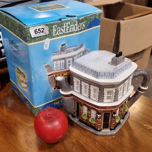 A novelty EastEnders ornamental teapot in the form of the Queen Victoria pub. Not intended for use. Complete in original box and packaging. "Get out of My Pub" or teapot.
