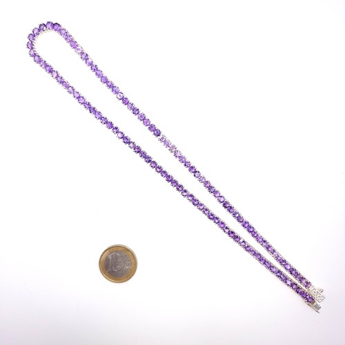 525 - A very nice example of a bright stoned amethyst necklace set in sterling silver, length 46cm, weight... 