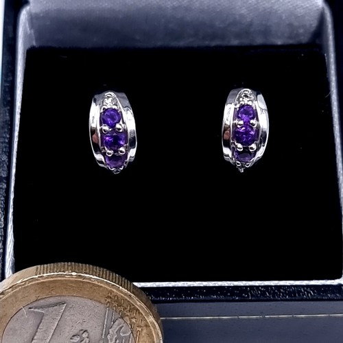 530 - Star Lot : A very fine pair of 9K white gold stud earrings (marked to posts), set with amethyst and ... 