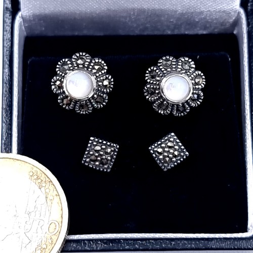 532 - two pairs of vintage sterling silver stud earrings, set with moonstones with diamond cut marcasite m... 