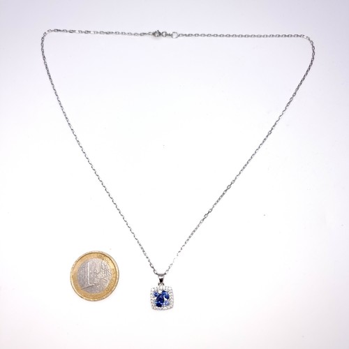 537 - A very nice example of a tazanite pendant necklace with gem stone surround together with a bright cu... 