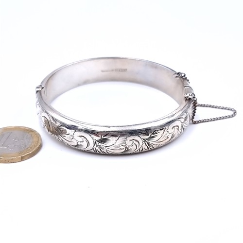 539 - A sterling silver bracelet hallmarked Birmingham with a nicely embossed band together with safety ch... 