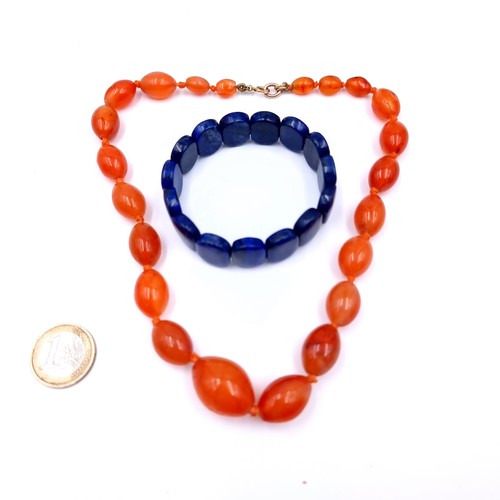 541 - Two items of vintage gem stone jewellery consisting of a carnelian graduated stone necklace, length ... 