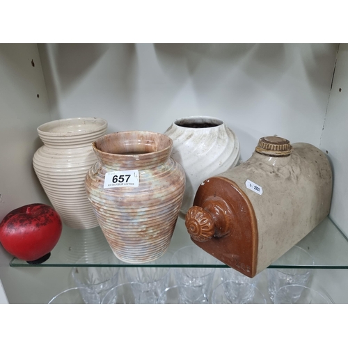 657 - Four items including three hand thrown vases and a vintage hot water bottle.