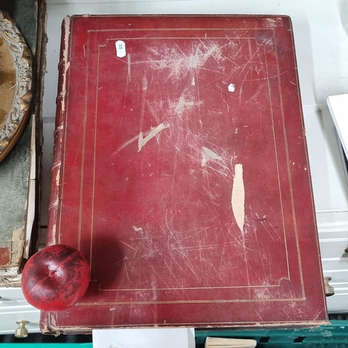 665 - A large antique red leather bound hardback book titled 