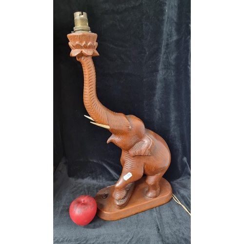 702 - A beautiful 1940's carved wooden table lamp in the form of an elephant.